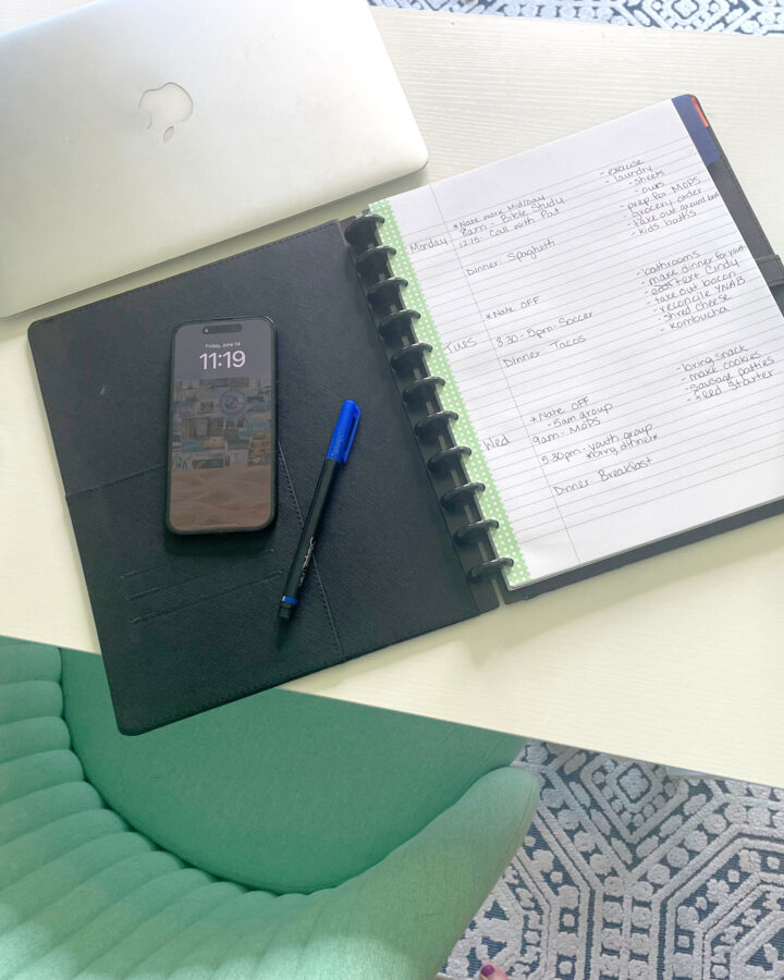 paper planner, phone, laptop and tea on desk